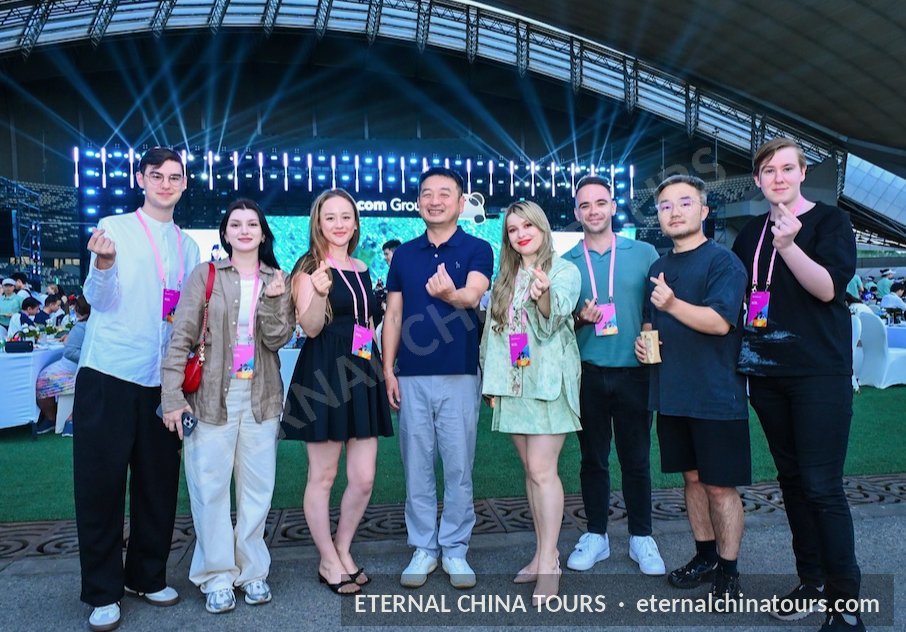 The whole group posing inside a stadium arena